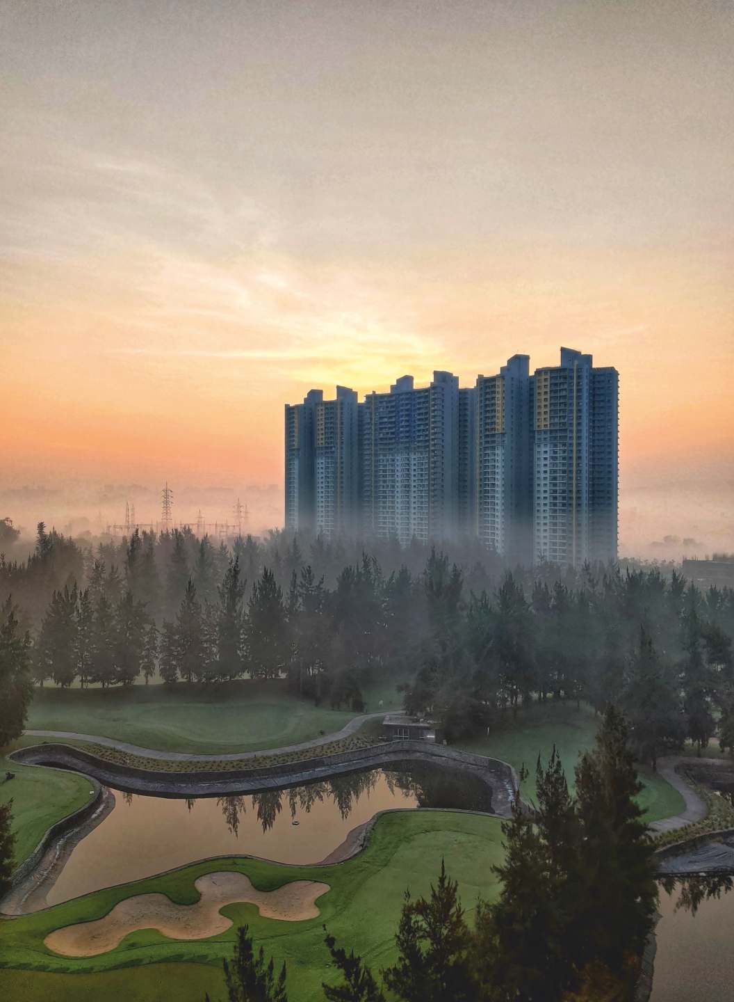Blue Ridge towers at misty sunrise over the golf course, Hinjawadi